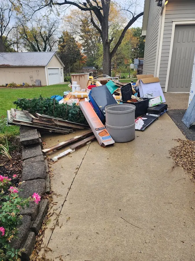 Dumpster being loaded with debris for Estate Cleanout Dumpster Rental in Stafford